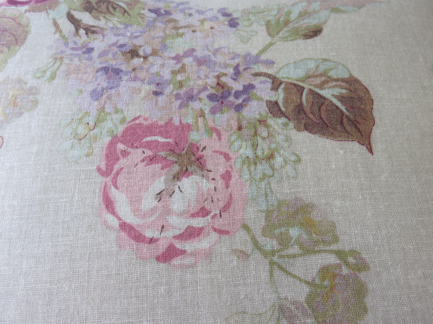 pink rose on tan linen pillow cover with purple lilacs