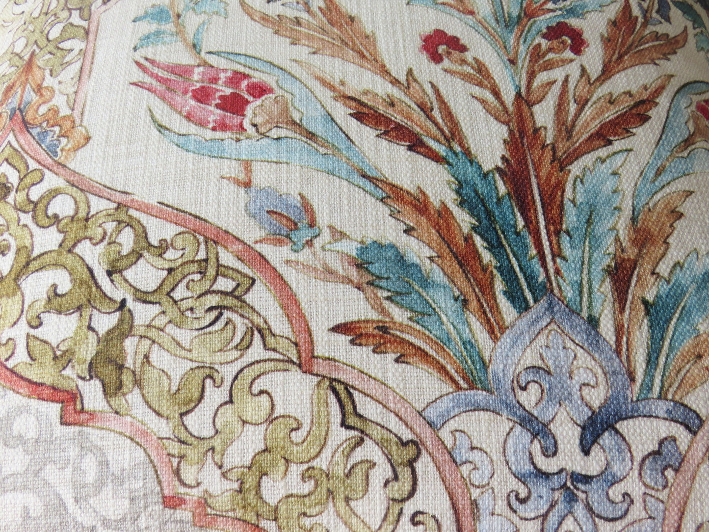 beautiful watercolor printed pillow cover on soft white cotton, featuring floral medallions and fretwork in hades of coral, aqua, red, blue, sage green, and grey
