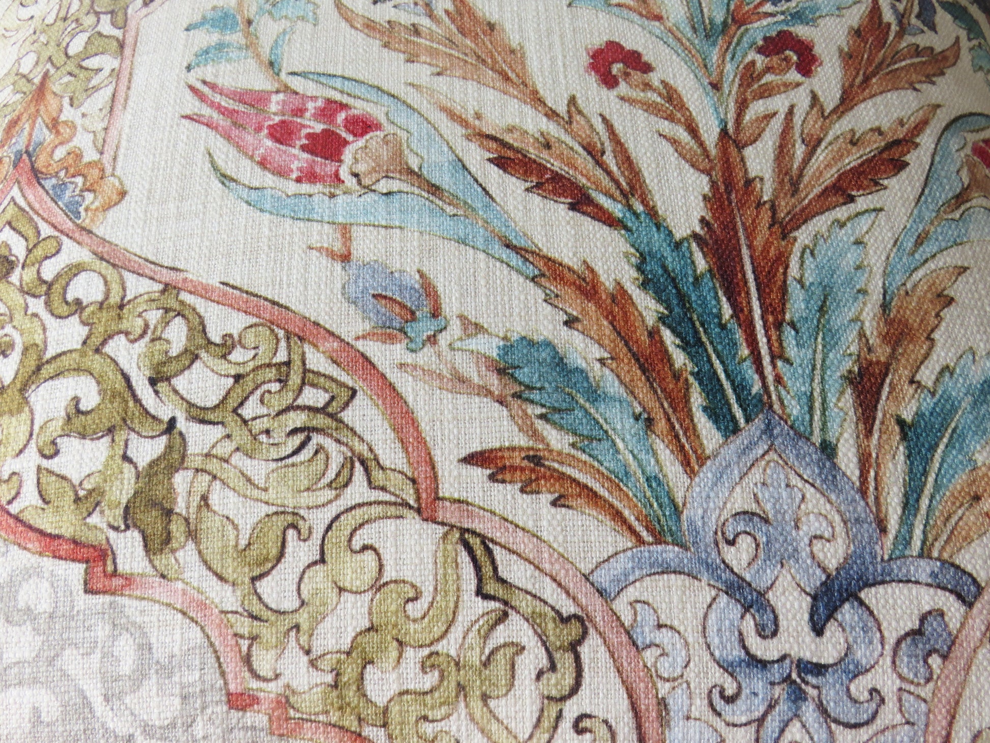 beautiful watercolor printed pillow cover on soft white cotton, featuring floral medallions and fretwork in hades of coral, aqua, red, blue, sage green, and grey