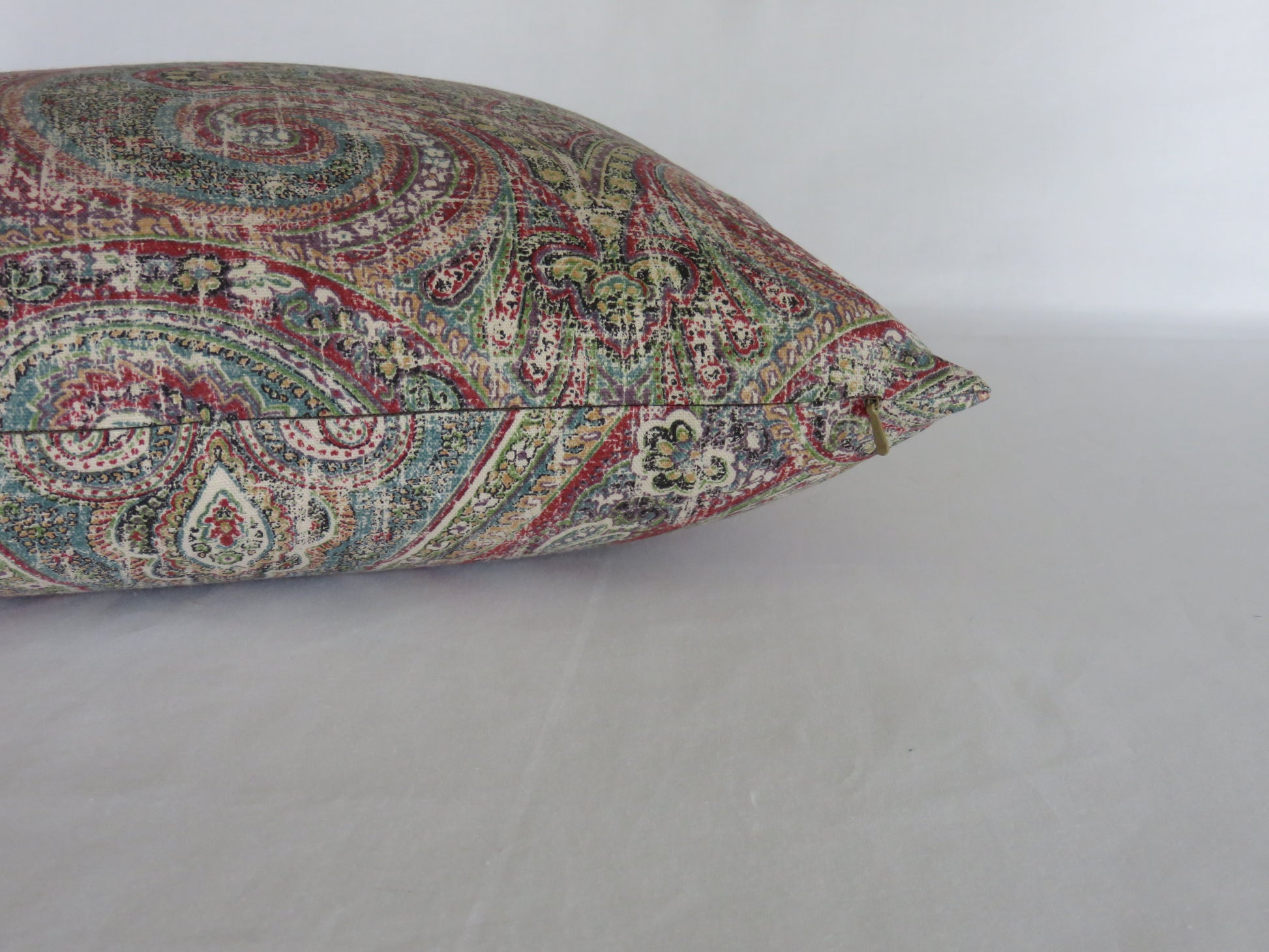 colorful distressed paisley pillow cover in teal, red, green