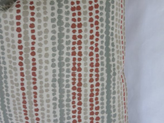 terracotta orange and grey rows of dots pillow